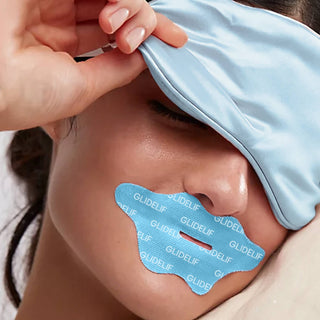 Person applying a blue GLIDELIF product to their face with a blue glove.